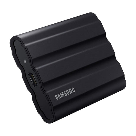 Samsung T7 Shield Portable SSD 1TB, USB 3.2 Gen 2, IP65 Rugged, Black, MU-PE1T0S/AM — Samsung T7 Shield portable SSD in black with its ribbed rubber casing, three-quarter view on a plain background
