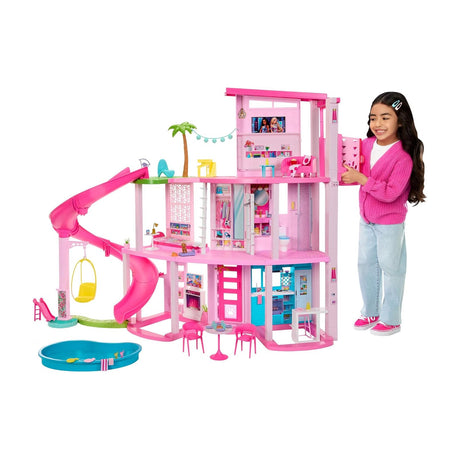 Barbie Dreamhouse Playset, 3 Stories with Pool, Slide and Elevator, 75+ Pieces — Fully assembled pink Barbie Dreamhouse, three stories with pool and slide, front view on a white background