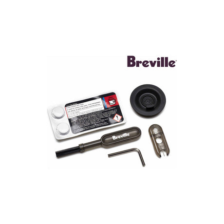 Breville Espresso Machine Cleaning Kit with Cleaning Tablets and Water Filters — Breville espresso machine cleaning kit laid out flat, showing white cleaning tablets, round water filter cartridges, a silicone cleaning disc and a cleaning brush on a plain 