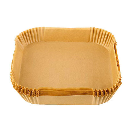 Cosori Air Fryer Parchment Liners, 100 Count, 7.9 in Square — A stack of square unbleached parchment air fryer liners with raised sides, one sitting inside an air fryer basket