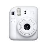 Fujifilm Instax Mini 12 Instant Film Camera — Fujifilm Instax Mini 12 instant camera, front three-quarter view showing the round lens barrel and selfie mirror