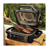 Ninja Woodfire 7-in-1 Outdoor Grill & Smoker, Electric, OG701 — Ninja Woodfire OG701 outdoor electric grill in grey with the lid open showing the grill grate, front three-quarter view