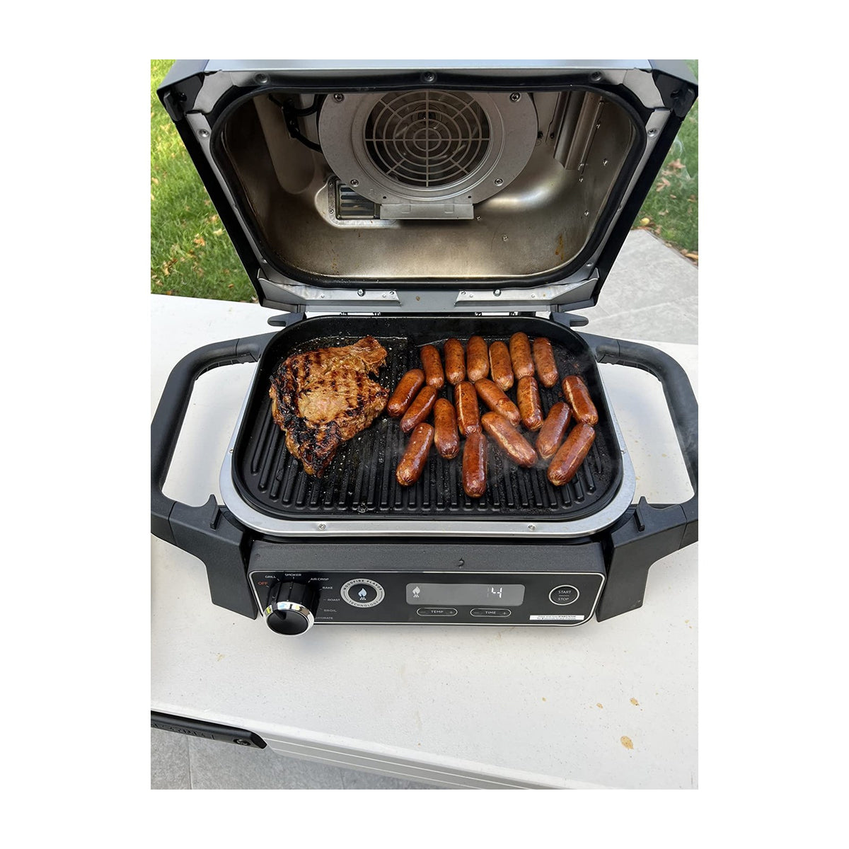 Ninja Woodfire 7-in-1 Outdoor Grill & Smoker, Electric, OG701 — Ninja Woodfire OG701 outdoor electric grill in grey with the lid open showing the grill grate, front three-quarter view