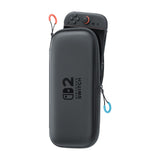 Nintendo Switch 2 Carrying Case & Screen Protector, Official Case with Six Game Card Slots — Official black Nintendo Switch 2 carrying case shown closed at a three-quarter angle, with the boxed screen protector beside it, plain white background