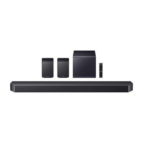 Samsung HW-Q990F 11.1.4ch Dolby Atmos Soundbar with Wireless Subwoofer and Rear Speakers — Samsung HW-Q990F soundbar with its wireless subwoofer and two rear speakers arranged together, front view on a plain background